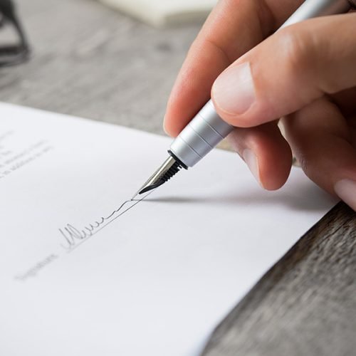 Person signing with a pen a Hamilton Ontario Wills Lawyer Will